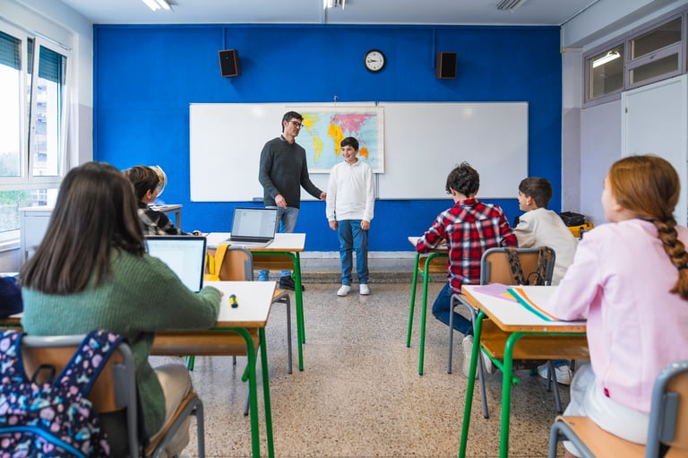 Elementary school students engaging in lessons with their teacher in a vibrant, modern classroom