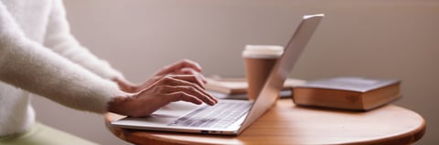 Adult learner engaged in focused online study from a comfortable home setting